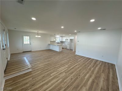 Unfurnished living room with sink and light wood-type flooring | Image 2