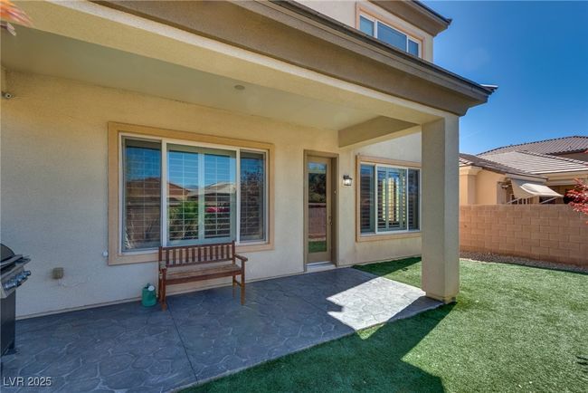 Entrance to property with fence, stucco siding, a patio, and a lawn | Image 65