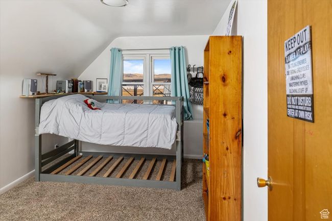 Carpeted bedroom featuring lofted ceiling | Image 29