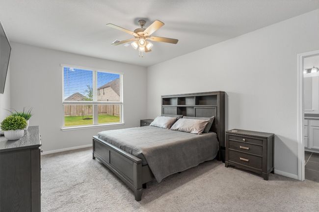 Bedroom with light carpet, baseboards, and connected bathroom | Image 13