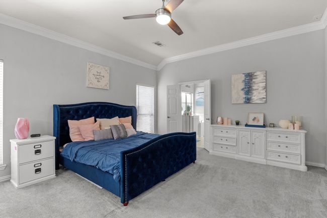 Bedroom featuring visible vents, light carpet, and ornamental molding | Image 22
