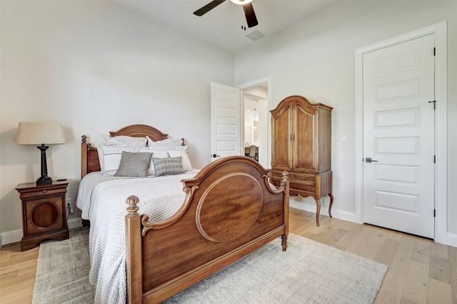 Bedroom featuring light wood floors and a ceiling fan | Image 21