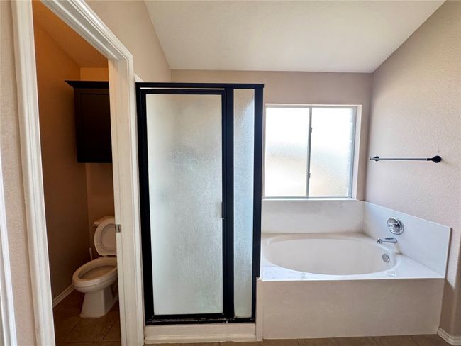 Bathroom featuring a shower stall, a bath, and tile patterned floors | Image 14