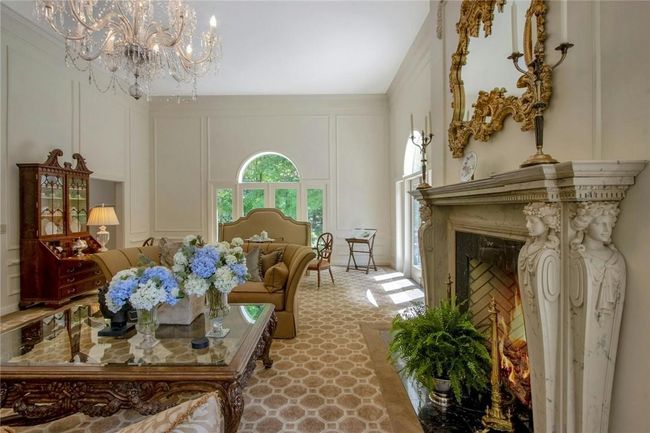 Living room featuring a premium fireplace and a chandelier | Image 11