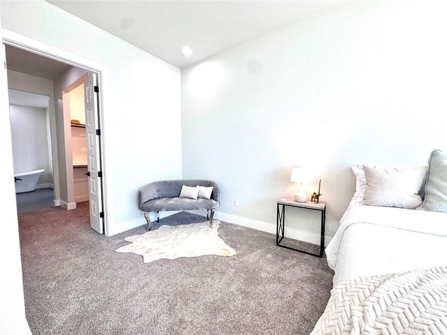 Carpeted bedroom featuring baseboards | Image 18