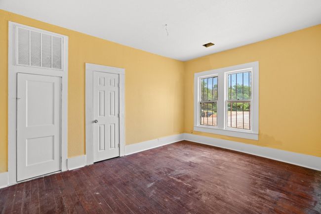 Spare room with wood-type flooring and baseboards | Image 9