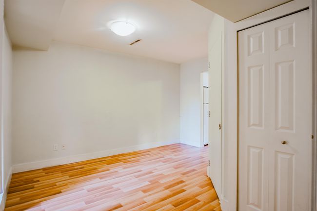 Empty room with light wood-type flooring, visible vents, and baseboards | Image 21