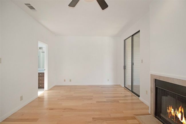 Original Image of the Primary Bedroom with Sliding doors to a Private Balcony. 2nd Wood Burning Fireplace | Image 12