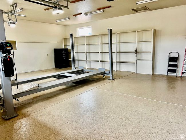 Garage with baseboards and a garage door opener | Image 52