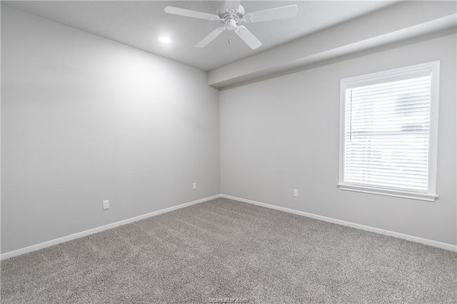 Carpeted empty room featuring ceiling fan | Image 17
