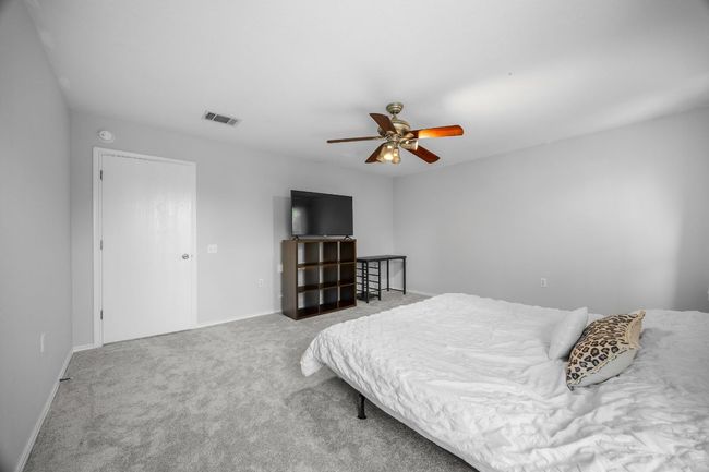 Newly carpeted primary bedroom features a ceiling fan. | Image 18
