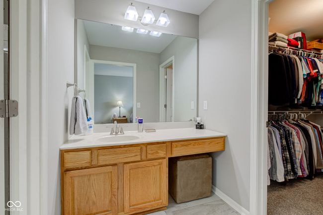 bathroom with vanity and a spacious closet | Image 14