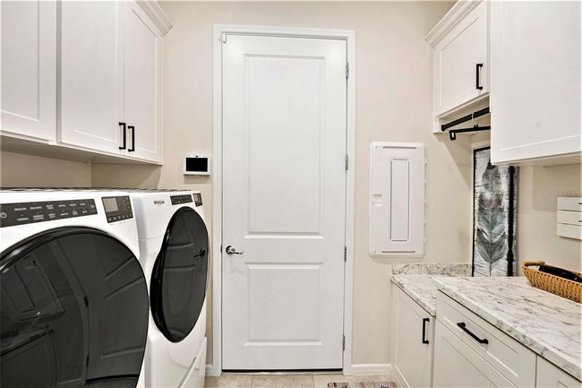 You'll love doing laundry in this indoors laundry room. Washer & Dryer convey. Custom cabinets and plenty of storage! | Image 18