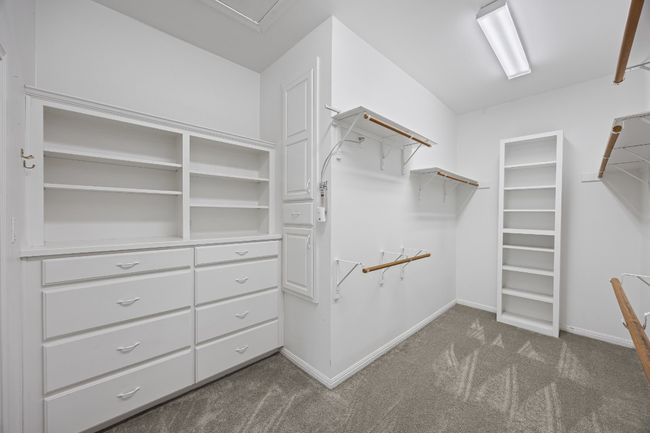 The spacious primary closet offers double hanging rows for maximum storage and a built-in dresser for added convenience and organization. | Image 28