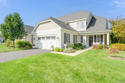 View of front of property featuring a front lawn and a garage | Image 1