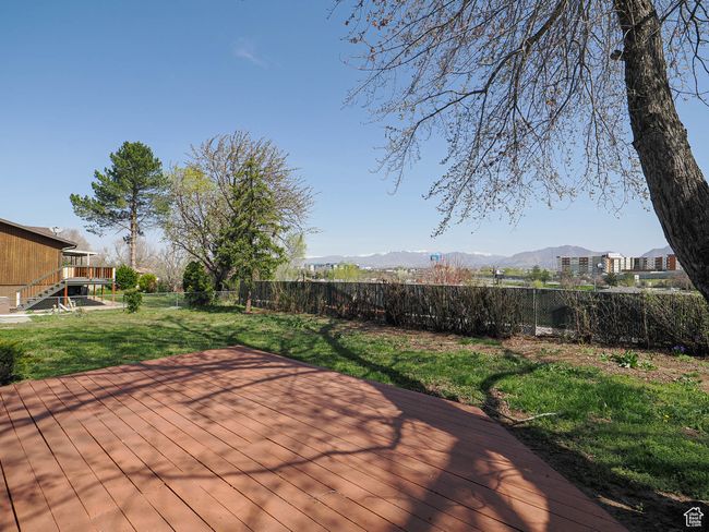Wooden terrace with a fenced backyard, a mountain view, and stairway | Image 20