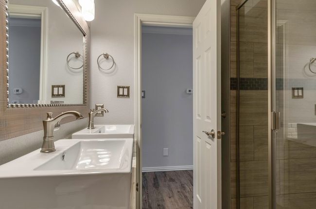 Full bath with a stall shower, wood finished floors, and double vanity | Image 31