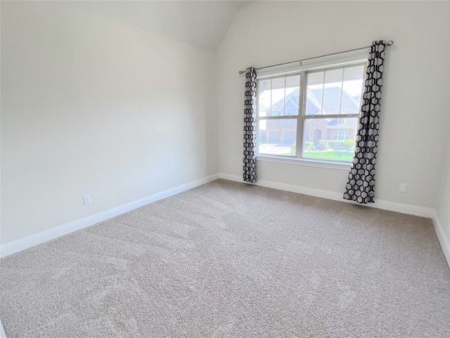 Spare room featuring vaulted ceiling and carpet | Image 29