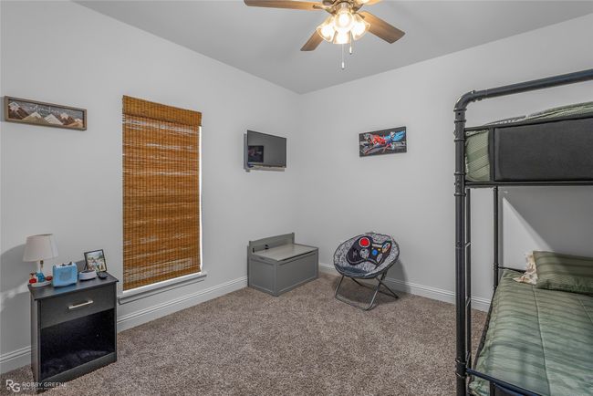 Carpeted bedroom with baseboards and a ceiling fan | Image 22