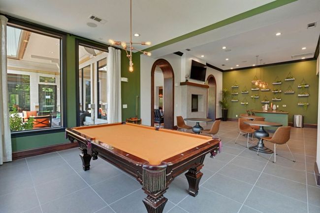 Recreation room with arched walkways, billiards, visible vents, and tile patterned floors | Image 11