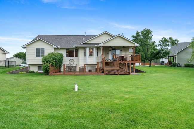 View of front of property featuring a ceiling fan, a front lawn, roof with shingles, and stairway | Image 25