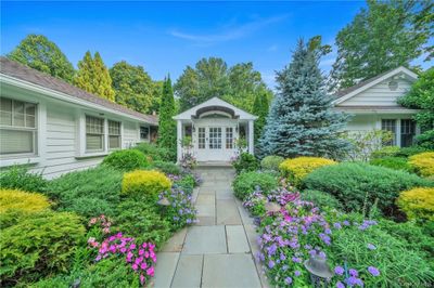 View of swimming pool featuring a patio, outdoor lounge area, and a lawn | Image 2