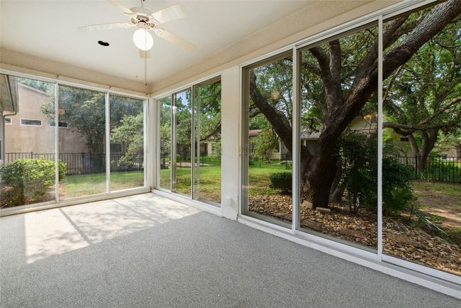 Unfurnished sunroom featuring a ceiling fan | Image 20