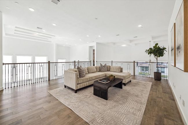 This dynamic space is uniquely positioned to overlook and open onto the first floor, offering a sense of connection and spaciousness throughout the home. | Image 27