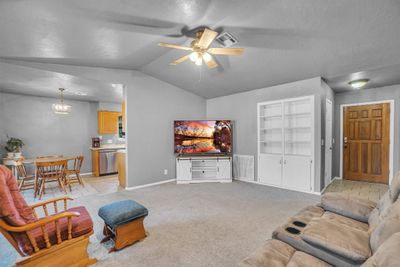 Living Room with built in bookshelf/display shelves and storage. | Image 3