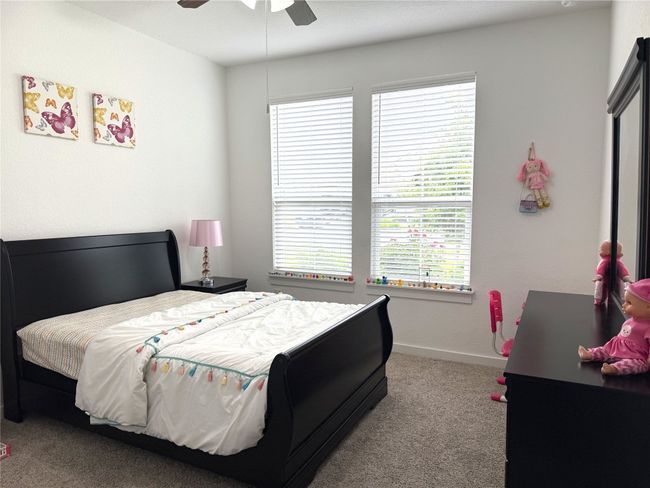 Bedroom featuring carpet floors, multiple windows, and baseboards | Image 15