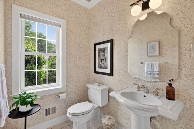 first floor half bath with crown molding, pedestal sink and large closet | Image 14