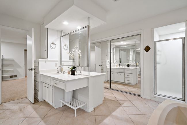 Full bathroom featuring two vanities, recessed lighting, tile floors, a stall shower and two closets | Image 8