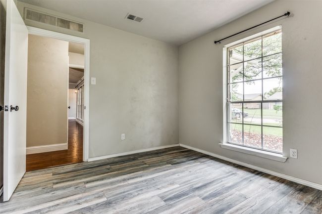 Spare room featuring wood finished floors and baseboards | Image 16