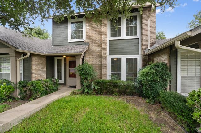 View of front facade with roof with shingles, brick siding, and a front yard | Image 5