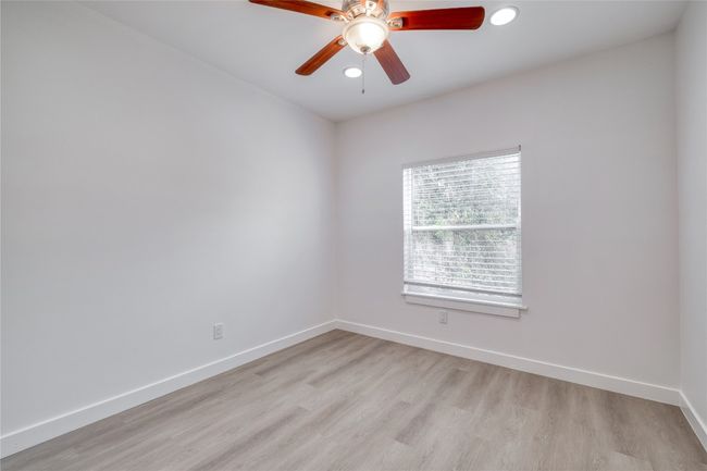 Spare room with light wood-type flooring, a ceiling fan, and recessed lighting | Image 12