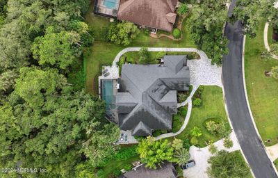 Overhead drone showing paver walkway around home on both sides | Image 3