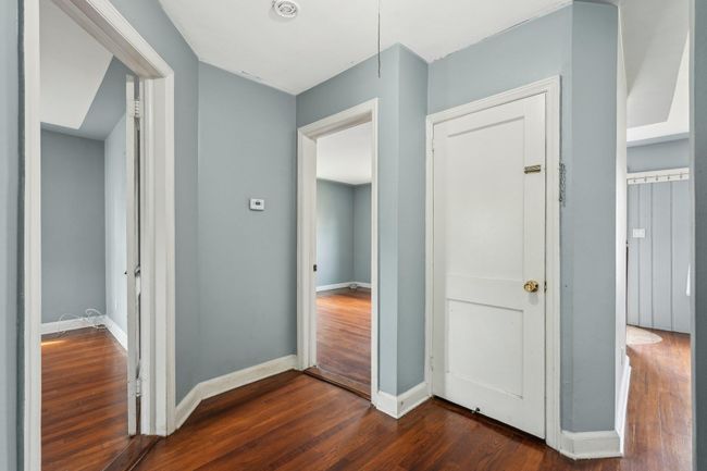 Hallway featuring dark wood-type flooring and baseboards | Image 8