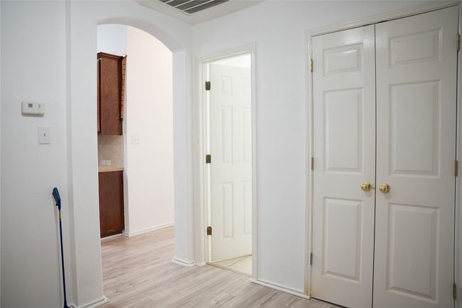 Hall with light wood finished floors, arched walkways, and baseboards | Image 10