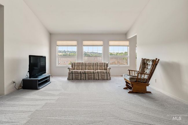 Carpeted living room with baseboards | Image 5