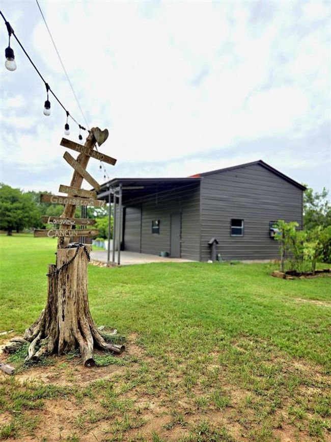 Take a look at the spacious barn dominium located on the property. Lights lead to the entrance. | Image 36