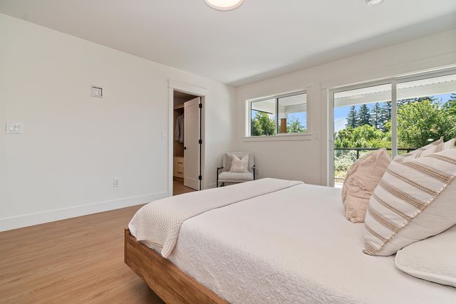 Bedroom with access to outside and light wood-style flooring | Image 19