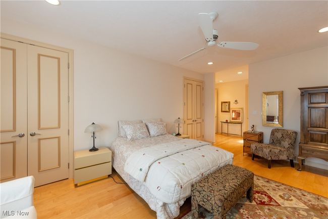 Primary Bedroom with view to walk-in closet. featuring recessed lighting, light wood finished floors, and ceiling fan | Image 30
