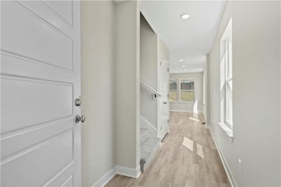 Corridor with light hardwood / wood-style floors | Image 3