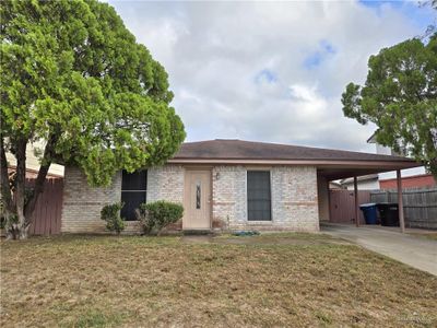 View of front of home with a front yard and a carport | Image 1