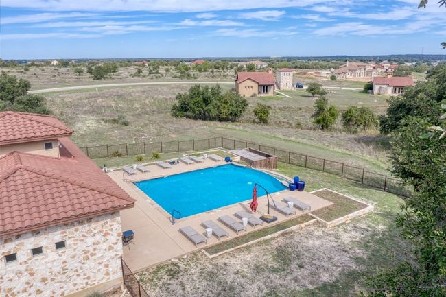 Pool with fence and a patio | Image 18