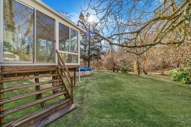 View of yard featuring a sunroom | Image 25