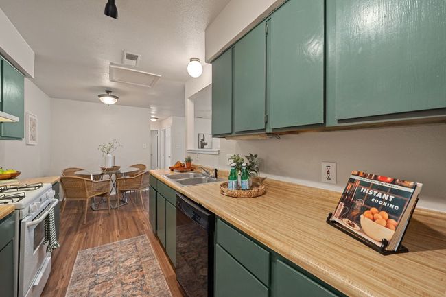 Galley-style kitchen with gas range, dishwasher, fridge and garbage disposal. | Image 10