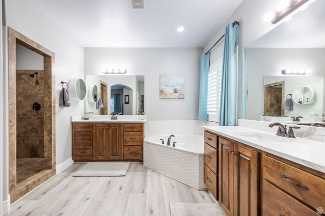 Bathroom featuring hardwood / wood-style flooring, plus walk in shower, and vanity | Image 16