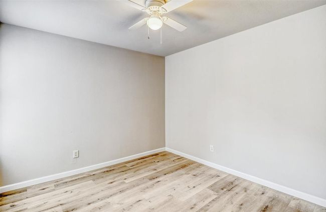 This home also includes two secondary bedrooms, each featuring vinyl flooring, decorator paint, and ceiling fans for added comfort. | Image 28