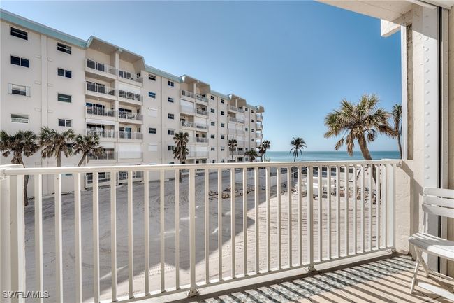 Balcony with a water view and a view of the beach | Image 4